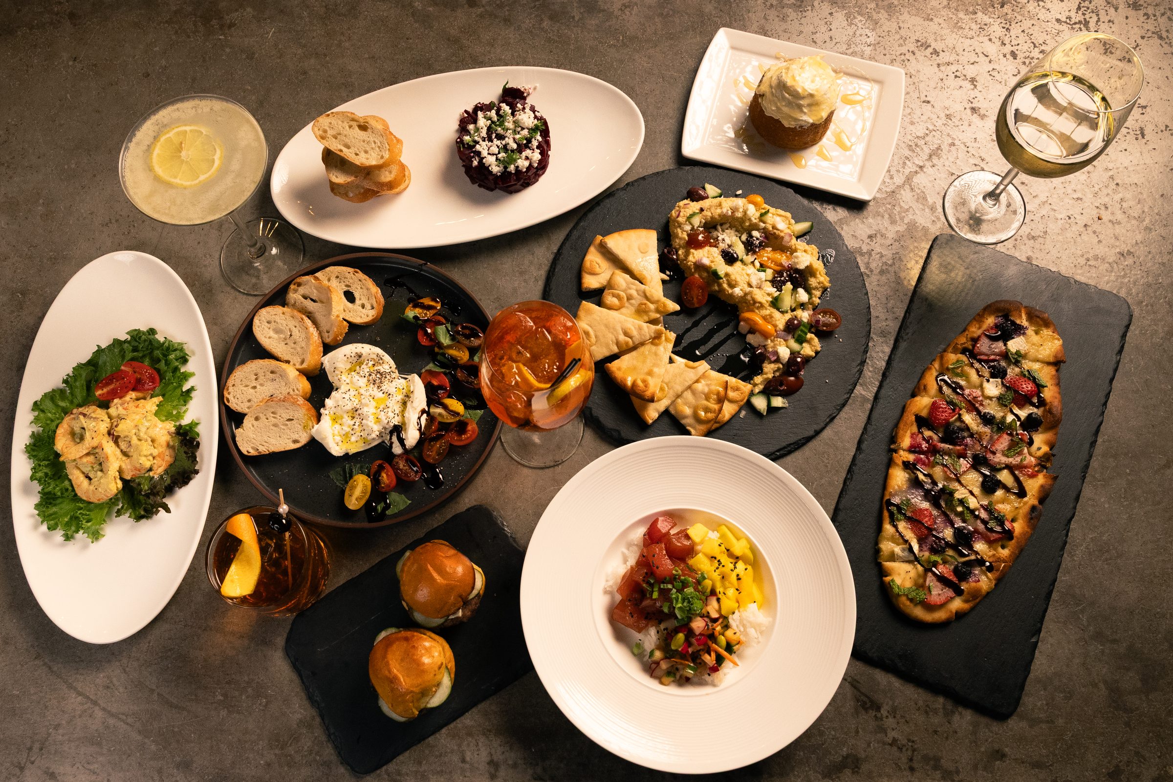 A spread of small plates and wine